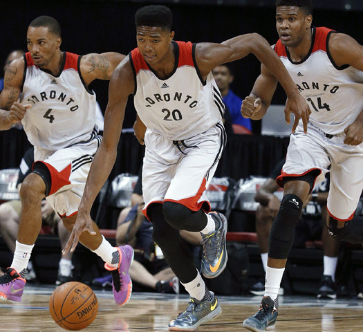 Toronto Raptors’ Bruno Caboclo, center, drives up the court with teammates Norman Powell, left, and Ronald Roberts during the first half of an NBA summer league basketball game against the Sacramento Kings on Friday, July 10, 2015, in Las Vegas. (AP Photo/John Locher)